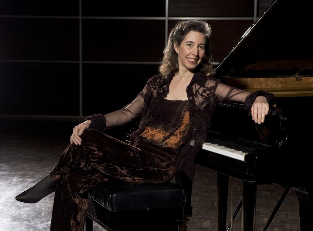 Woman posed in front of piano