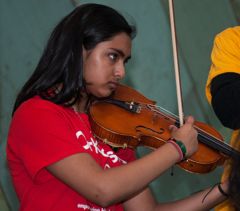 A young girl playing the violin