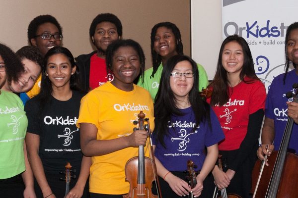 OrKidstra students smiling with instruments