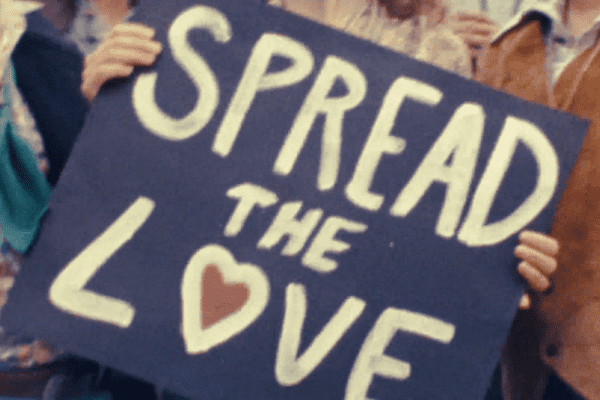 A photo of a sign that says "Spread The Love"
